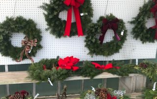 storefront Christmas wreaths display